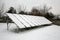 Photovoltaic panels covered with snow on a snowy day
