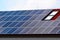 photovoltaic PV sun collector solar panels on sloped residential clay roof. sunshine and blue sky.