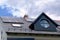 Photovoltaic solar panels installed on sloped metal roof. blue sky.