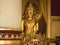 Phra Chao Thong Tip seated Buddha statue at Wihan Luang, the main prayer hall at Wat Phra Singh. Chiang Mai, Thailand.