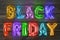 Phrase BLACK FRIDAY made of foil balloon letters on background