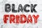 Phrase BLACK FRIDAY made of foil balloon letters on marble background