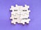 Phrase buy now pay later on wooden jigsaw puzzle against purple background.