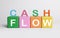Phrase Cash Flow made with letters and colorful cubes on white background