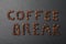 Phrase Coffee Break made of beans on black background, flat lay