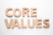 Phrase CORE VALUES made of wooden letters on white background, top view