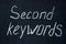 The phrase on the dark board is `second keywords`