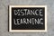 Phrase `Distance Learning` written on a blackboard