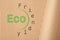 Phrase Eco Friendly written on cardboard, top view