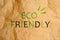 Phrase Eco Friendly written on crumpled kraft paper, top view