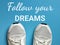 Phrase Follow your dreams written on blue background with sports shoes.