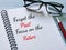 Phrase forget the past focus on the future written on notebook with a pen.