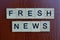 Phrase fresh news made from gray wooden letters