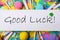 Phrase GOOD LUCK written on white note and party decor