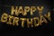 Phrase HAPPY BIRTHDAY made of golden balloon letters