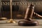 Phrase Inheritance law and wooden gavel on table, closeup