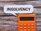 Phrase insolvency written on bubble speech with calculator.