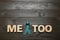 Phrase Me Too made of letters and teal awareness ribbon on wooden background, top view. Stop sexual