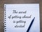 Phrase THE SECRET OF GETTING AHEAD IS GETTING STARTED written on a piece of paper