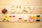 Phrase Stay at Home from toy constructor on wooden background.