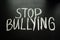 Phrase `stop bullying ` on chalkboard