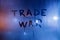 The phrase trade war handwritten on classic blue night wet window glass