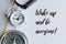 Phrase WAKE UP AND BE AWESOME! written on notebook with clock, watch and compass