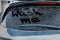 Phrase Wash Me written on dirty car window outdoors, closeup