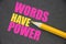 The phrase Words Have Power written with yellow pencil on texturized dark grey paper. Copywriting PR publishing business concept