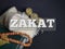 Phrase ZAKAT with blurry background.