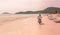 Phu Quoc Island, Vietnam: Unidentified Ice cream sailor driving motorcycle at sandy beach