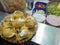 Phuchka or panipuri or golgappa served on a plate with curd or dahi in traditional chaat seller in india. closeup shot of