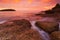 Phuket beach at Sunrise with interesting rocks in foreground