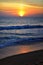 Phuket beach sunset, colorful cloudy twilight sky reflecting on the sand gazing at the Indian Ocean, Thailand