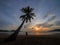 Phuket, Thailand. Tropical beach paradise with beach swing with women sitting. sunset with silhouette women relax on swing under