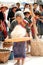 Phutai minority woman pounding and winnowing rice.