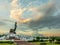 Phutthamonthon Buddha walking statue under evening cloudy sky in Thailand