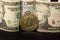 Physical bitcoin next to dollar bills