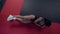 physical exercise for good legs shape, sportswoman is lying on floor and lifting leg up