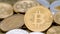 Physical metal golden Bitcoin currency rotating over others coins. BTC