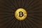 Physical shiny bitcoin agains dark background