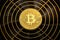 Physical shiny bitcoin agains dark background