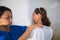 Physical therapist checking senior woman shoulder during medical checkup