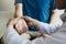 Physical therapist checks the patient wrist by pressing the wrist bone in clinic room