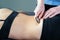 Physical therapist fixing sacroiliac joint pain with IASTM tool