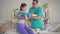 Physical therapist in uniform sticks a special kinesiotape on the patient\'s hand