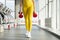 Physically fit woman at the gym with dumbbells ready to strengthen her arms and biceps