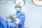 Physician assistant or male surgeon Is wearing gloves to the doctor to prepare for surgery while standing in a sterile area in the