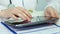 Physician browsing pages on tablet, consulting patients online, keeping records