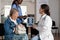 Physician doctor explaining medical radiography to elderly senior woman